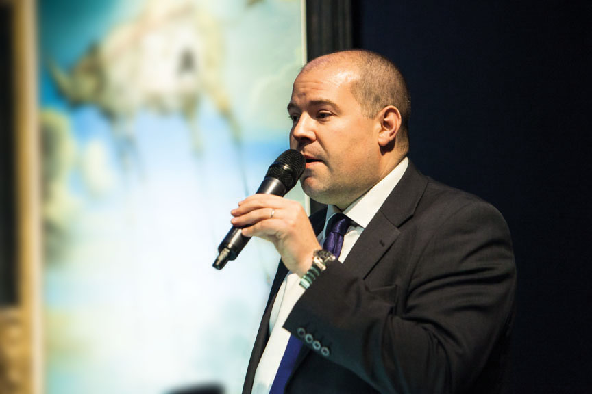 Jay Vincze working in a gallery or auction setting